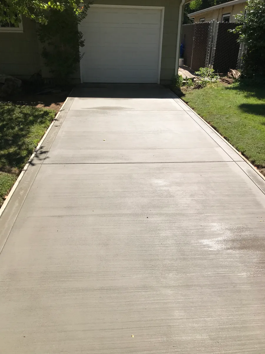Concrete driveway leading to a residential garage